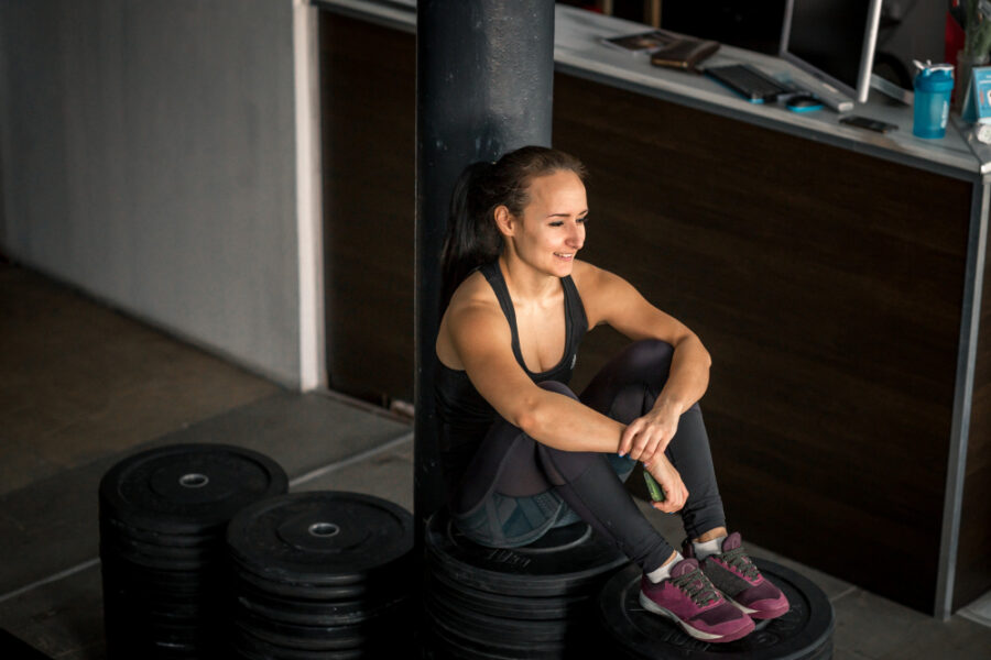 Woman in the gym sitting down