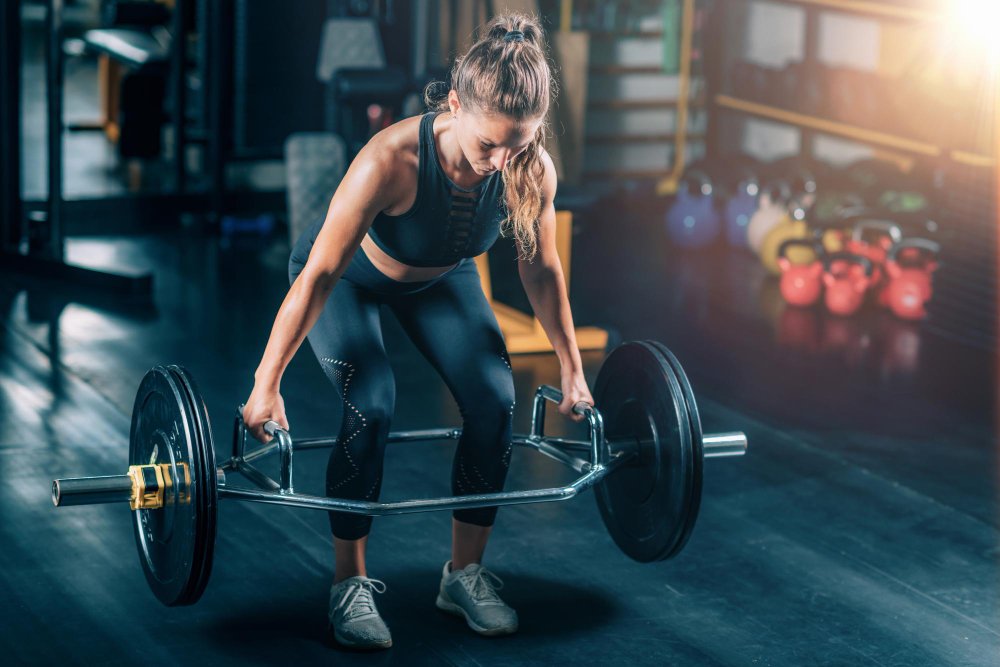 Woman lifting heavy for better health