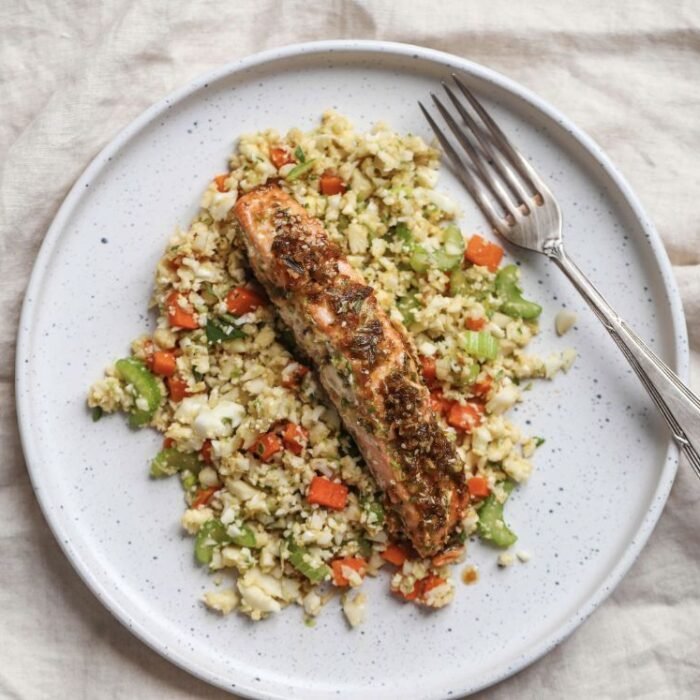 Juicy peace of salmon on bed of cauliflower fried rice.