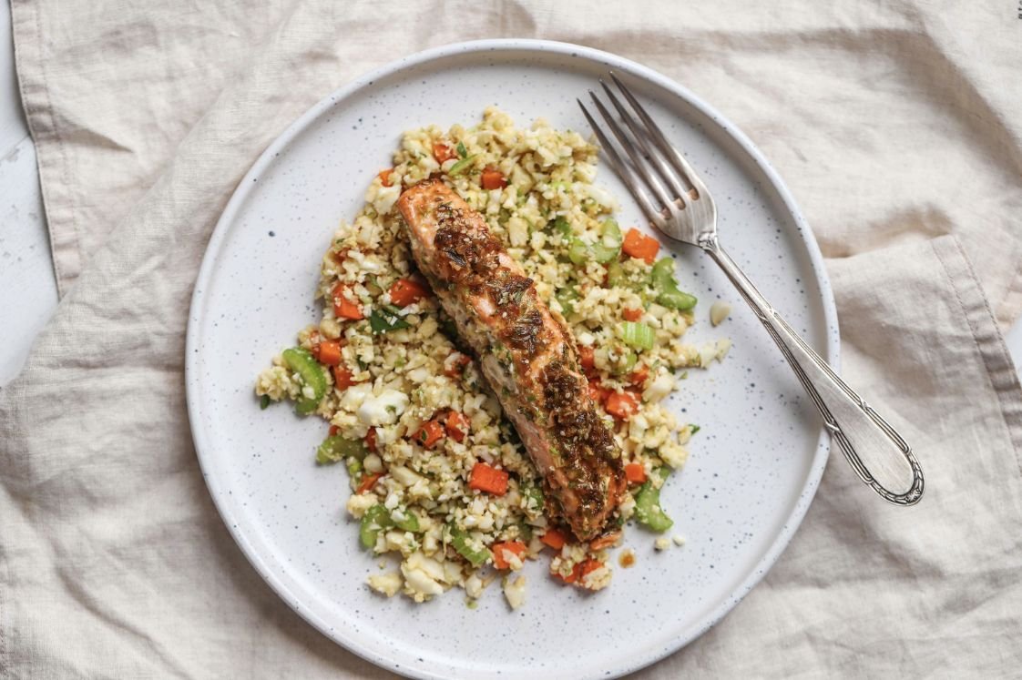 Juicy peace of salmon on bed of cauliflower fried rice.
