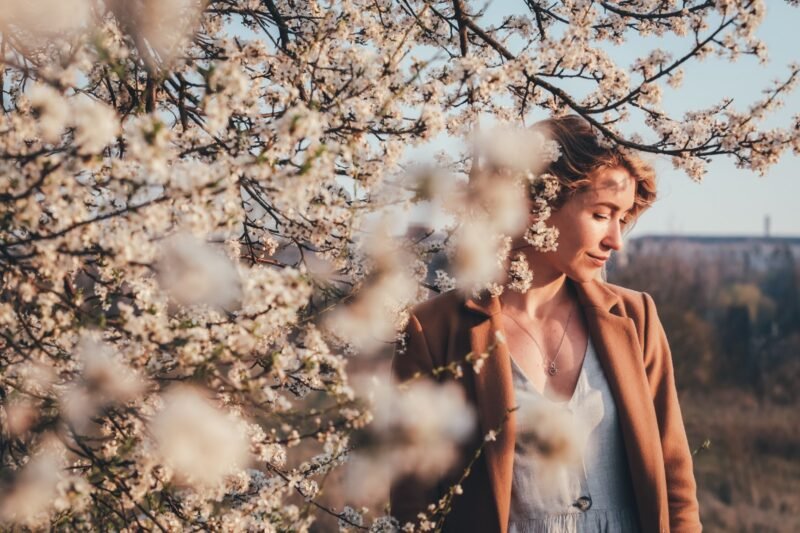 Woman near a beautiful tree of flowers