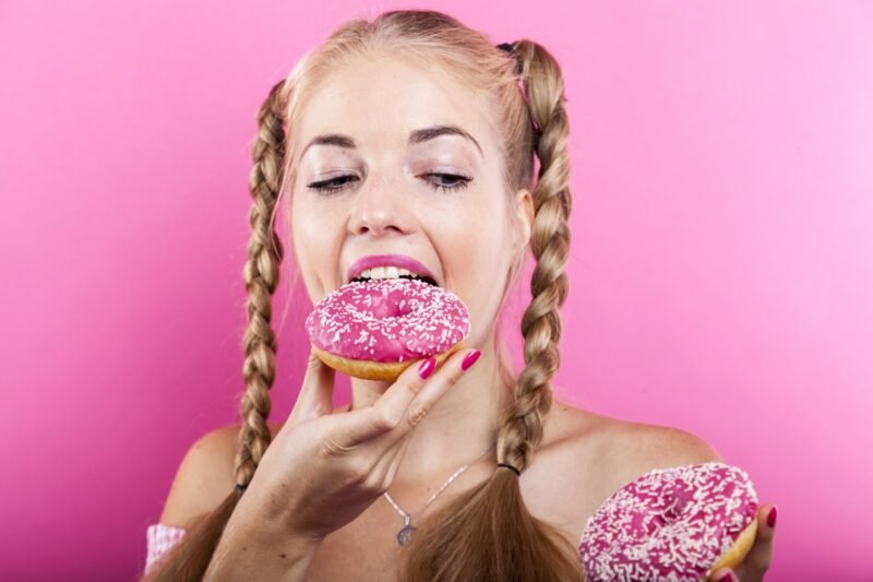 Image of woman eating pink douthit