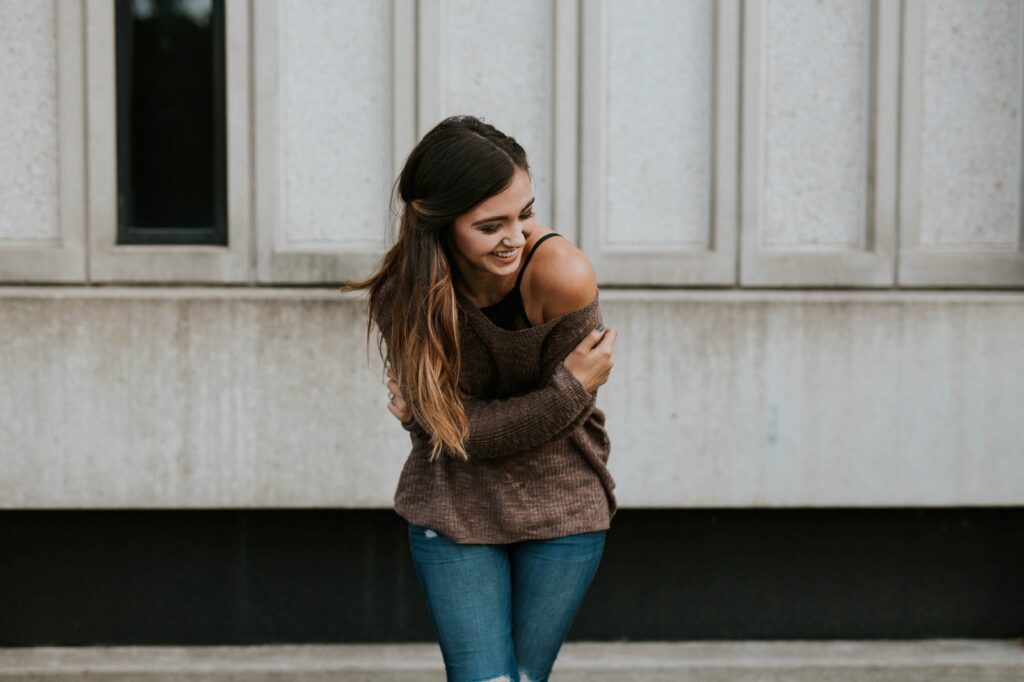 Happy woman holding herself