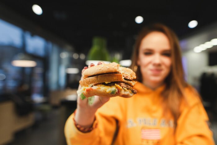 Woman holding burger