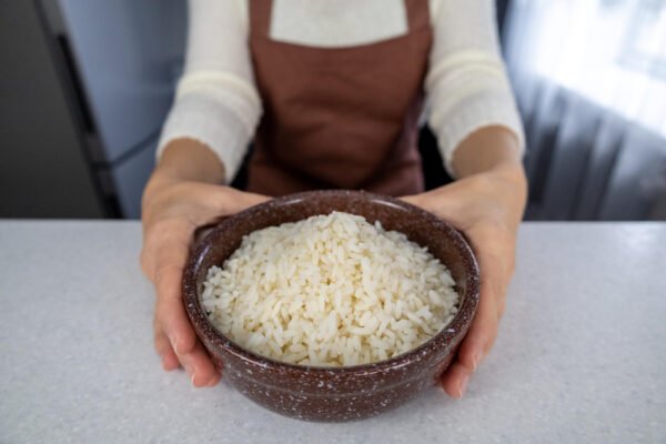 Woman with a bowl of white rice