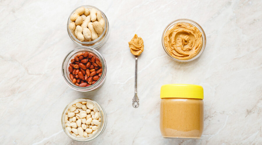 Peanuts with peanut butter on a spoon