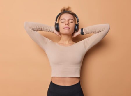 Fit woman with headphones tired after a hard workout