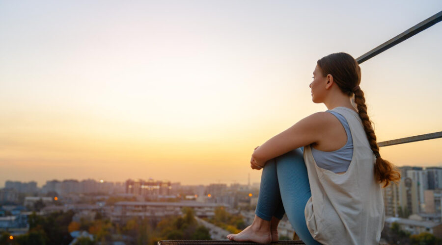 Woman enjoying the marvelous view of city at dusk