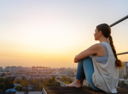 Woman enjoying the marvelous view of city at dusk