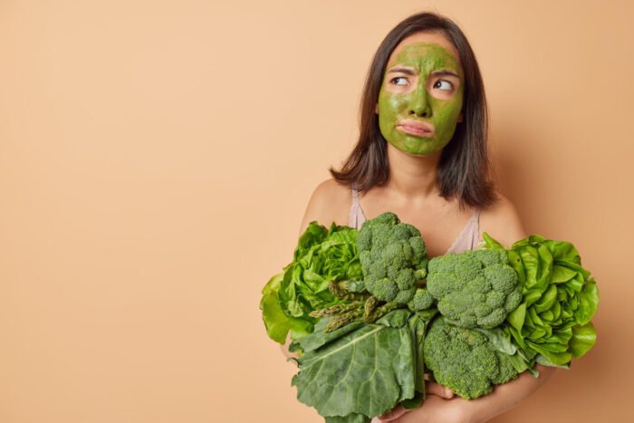 Woman with an arm full of greens