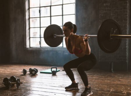 Woman squatting with a heavy bar