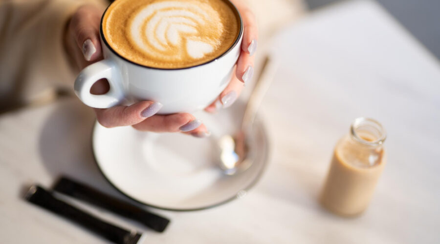 Woman holding a warm cup of coffee