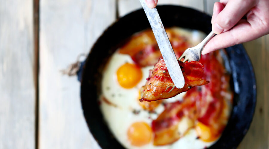 Egg and bacon fried in a pan