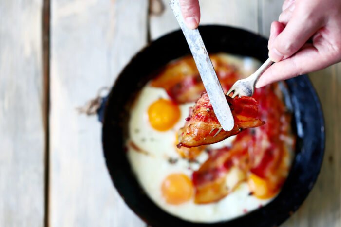 Egg and bacon fried in a pan
