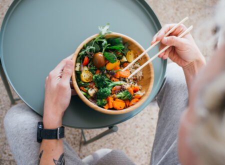 A woman eating a Healthy green bowl of nutrients