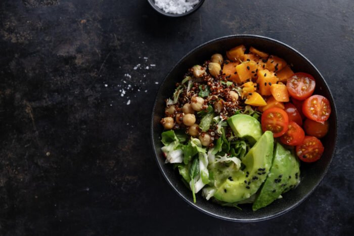 A healthy bowl of vegetables with avocado and quinoa