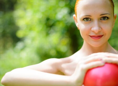 Image of a pretty lady holding a red heart or ball