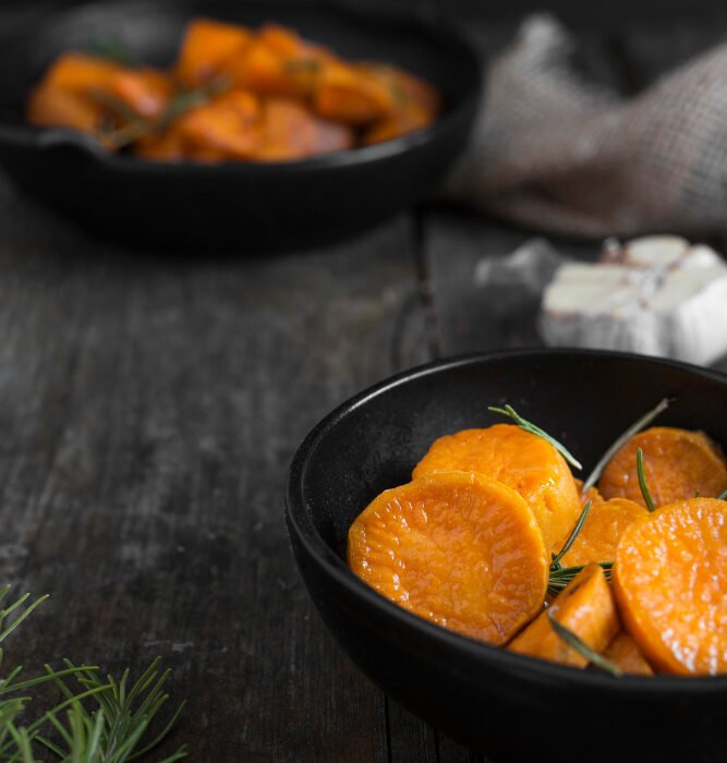 Cooked and sliced sweet potato in a black bowl