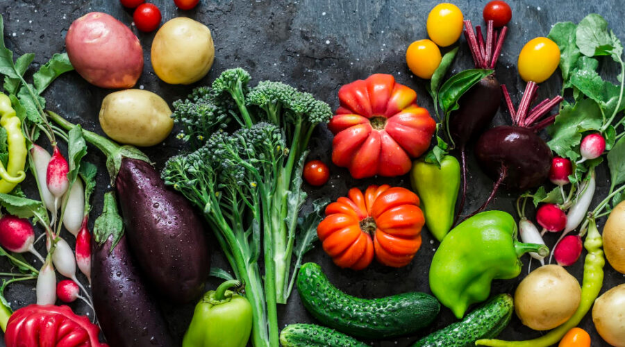 A flat lay image of many different vegetables beneficial for gut health