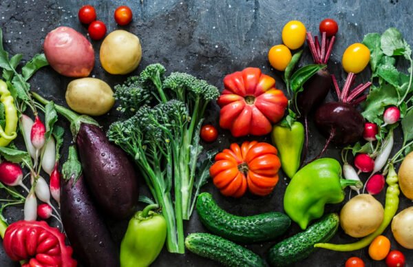 A flat lay image of many different vegetables beneficial for gut health