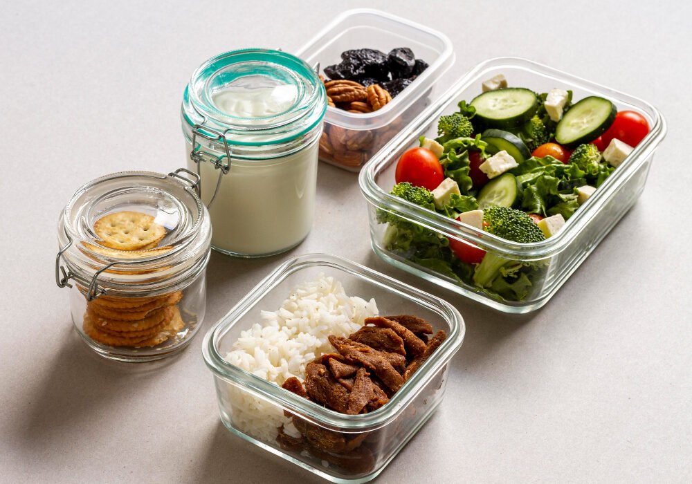 A group of food preparation containers with healthy foods