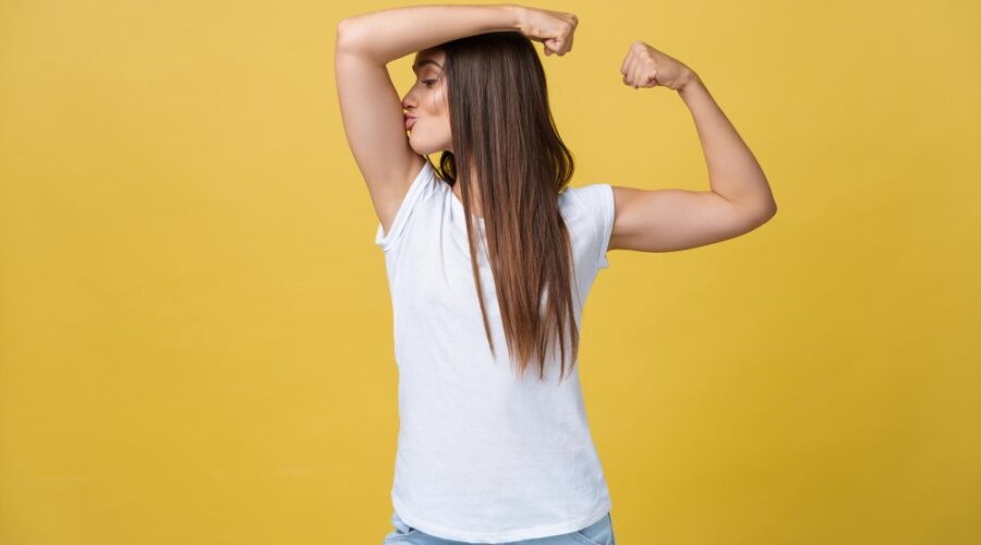 Image of woman kissing her biceps