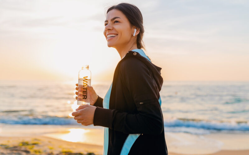 Woman drinking water in the morning to hydrate herself