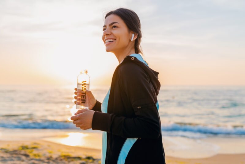 Woman drinking water in the morning to hydrate herself