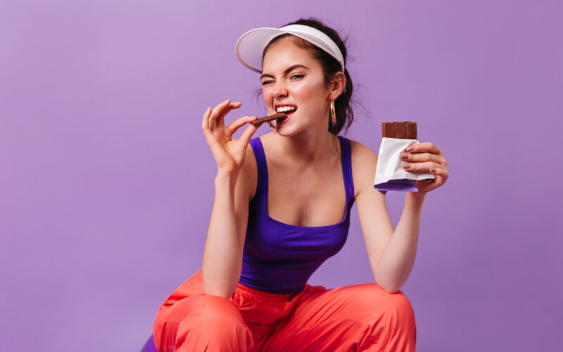 Woman eating delicious chocolate for her health & wellbeing