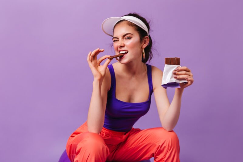 Woman eating delicious chocolate for her health & wellbeing