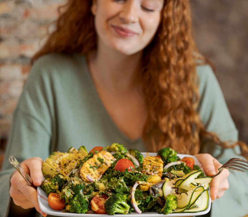 Woman eating an abundant plate of veggies