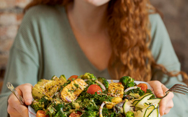 Woman eating an abundant plate of veggies