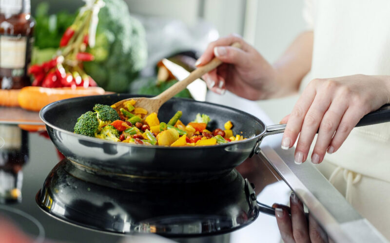 woman-cooking-vegetables-pan