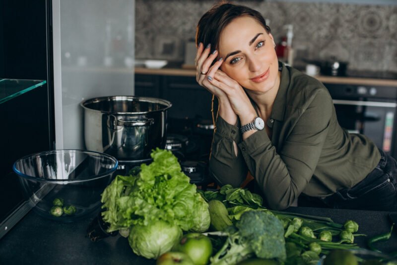 woman-with-green-vegetables-kitchen