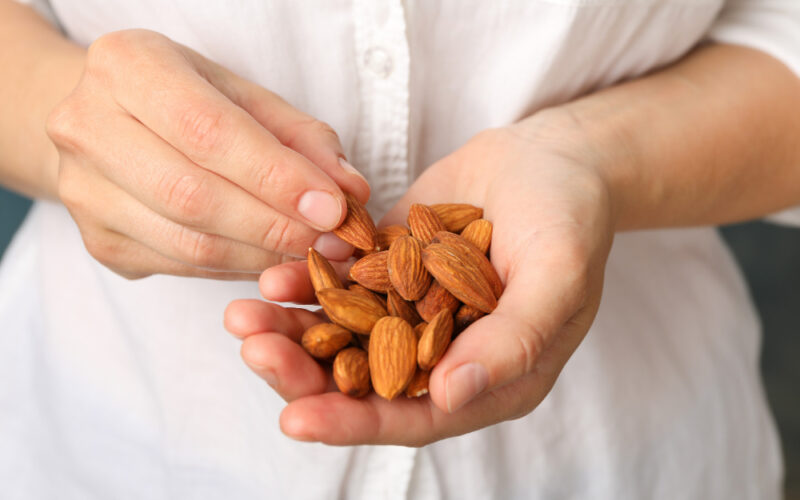 A woman who snacks on nuts knowing how important they are for good health and weight loss