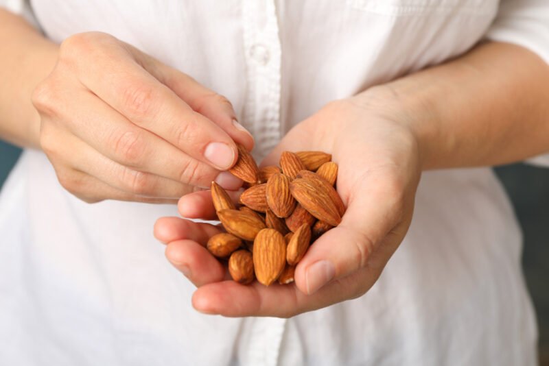 A woman who snacks on nuts knowing how important they are for good health and weight loss