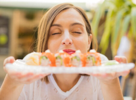 Woman loving her sushi plate and can't wait to eat