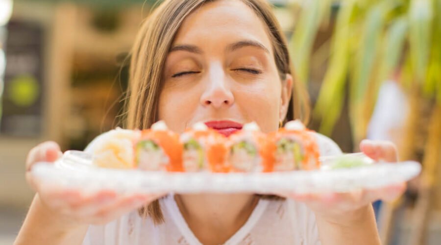 Woman loving her sushi plate and can't wait to eat