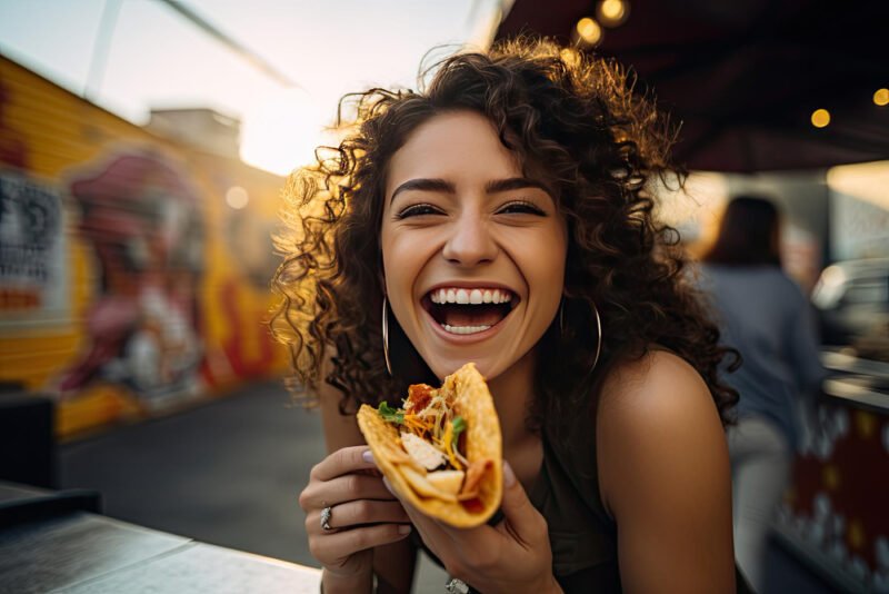 Woman happy eating tacos